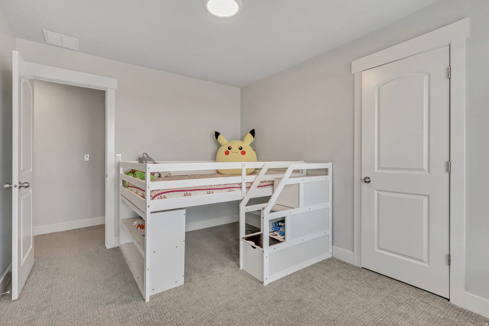 Bedroom featuring light colored carpet and baseboards