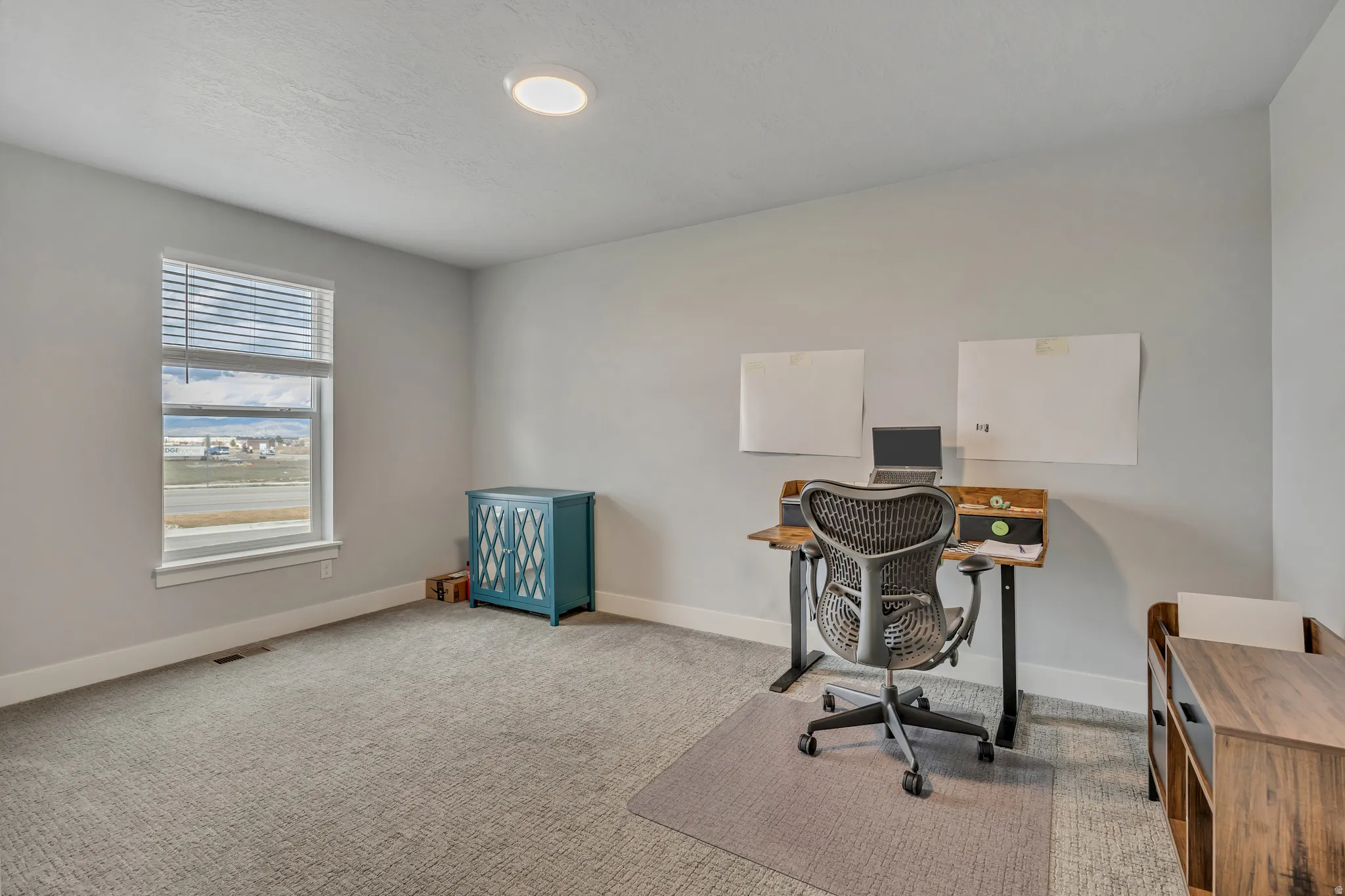 Home office with carpet and baseboards