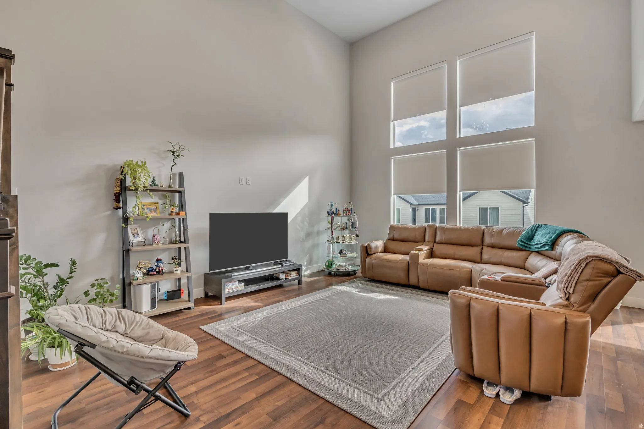 Living area featuring wood finished floors and a high ceiling