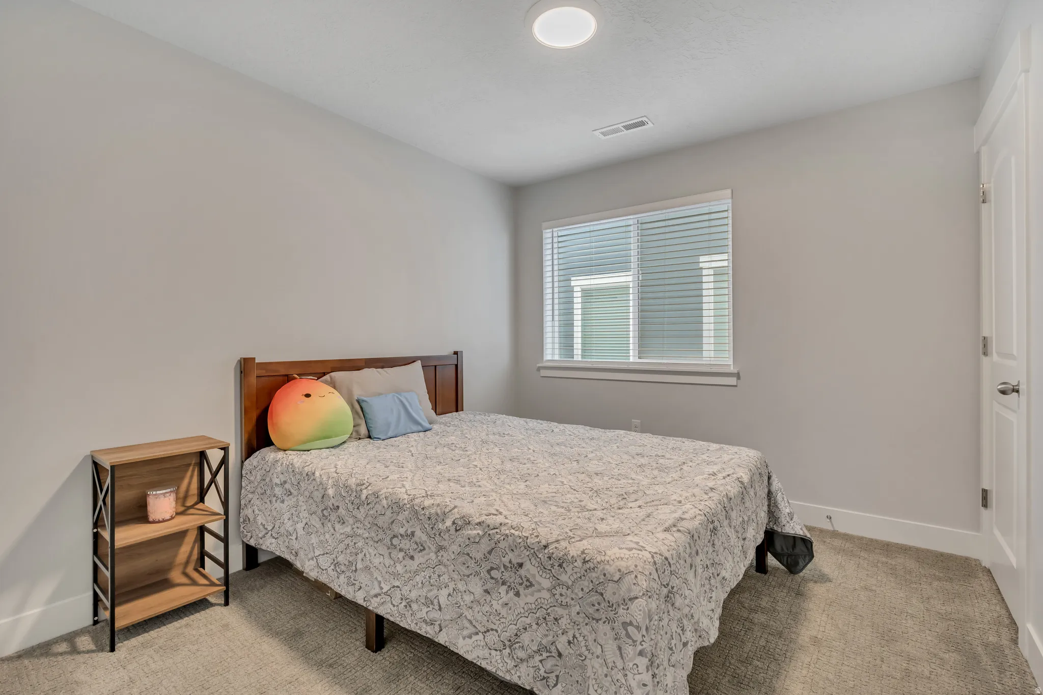 Bedroom with light carpet and baseboards