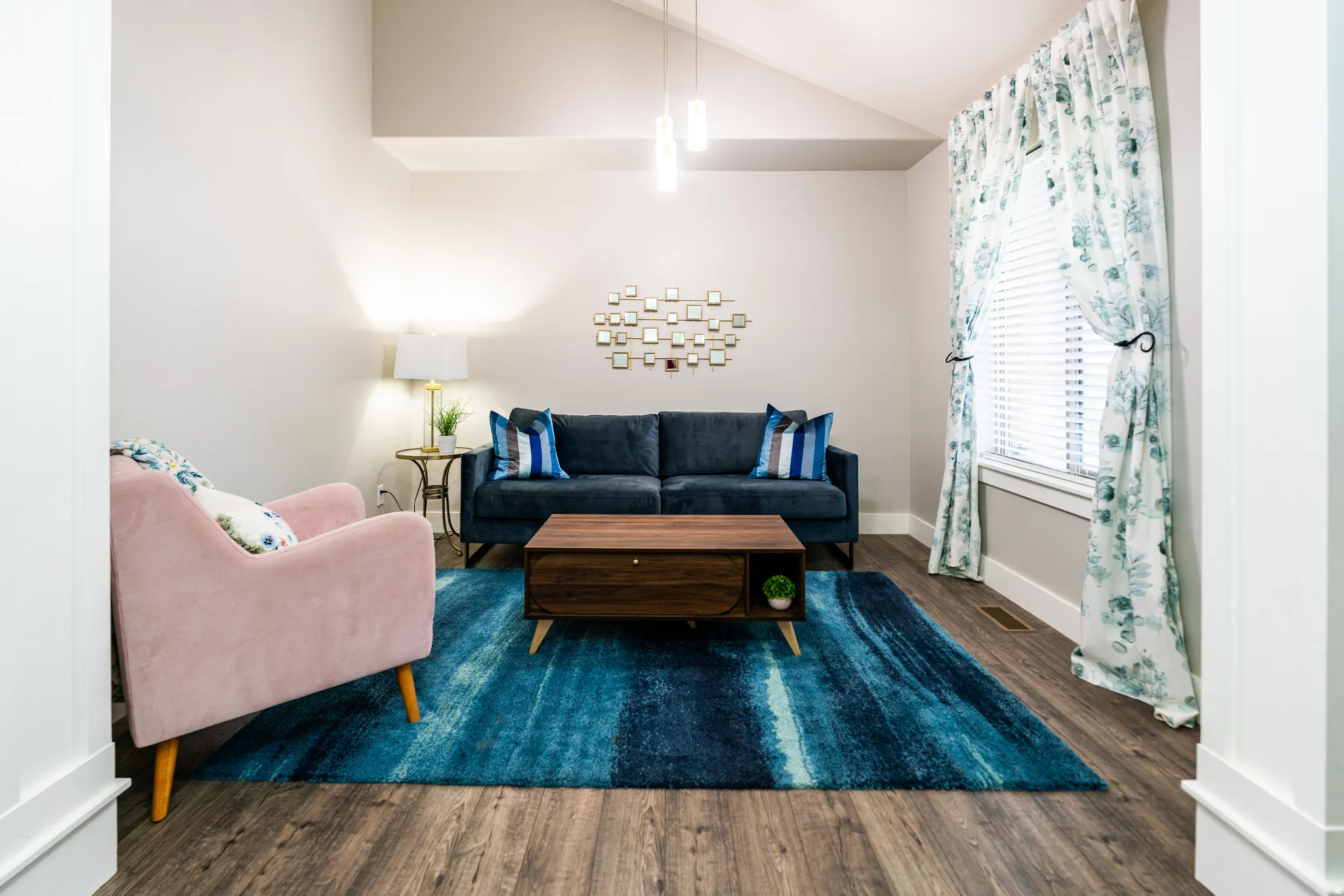 Living room featuring lofted ceiling and wood finished floors