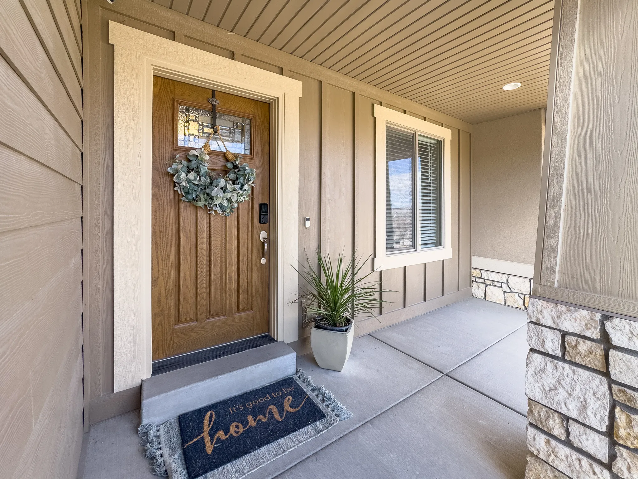Property entrance with a porch and stone siding