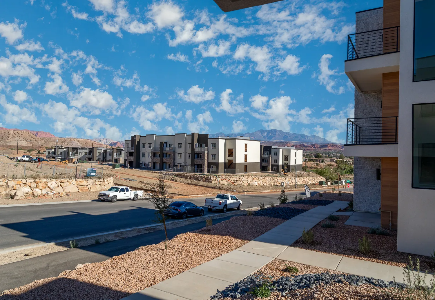 View of yard with a balcony and a mountain view