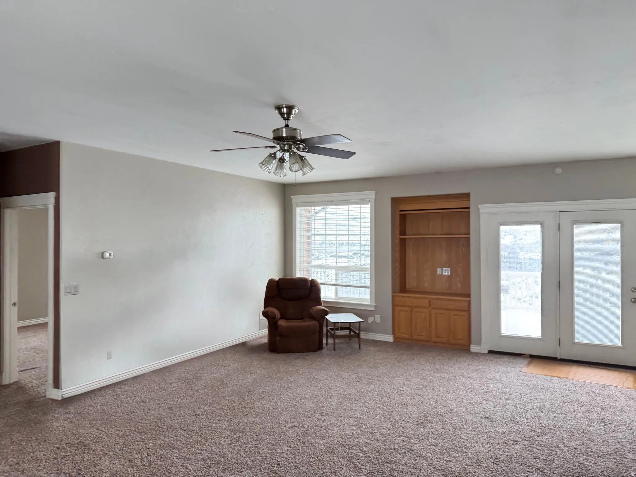 Sitting room with carpet floors and ceiling fan