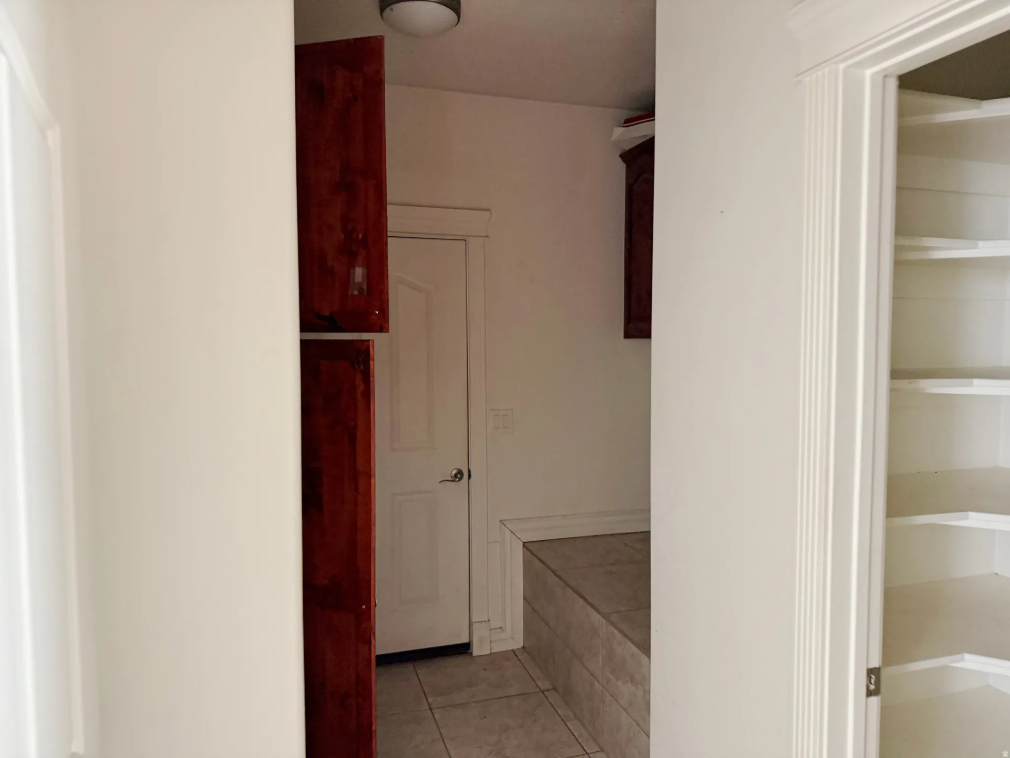 Bathroom featuring light tile patterned floors and a closet