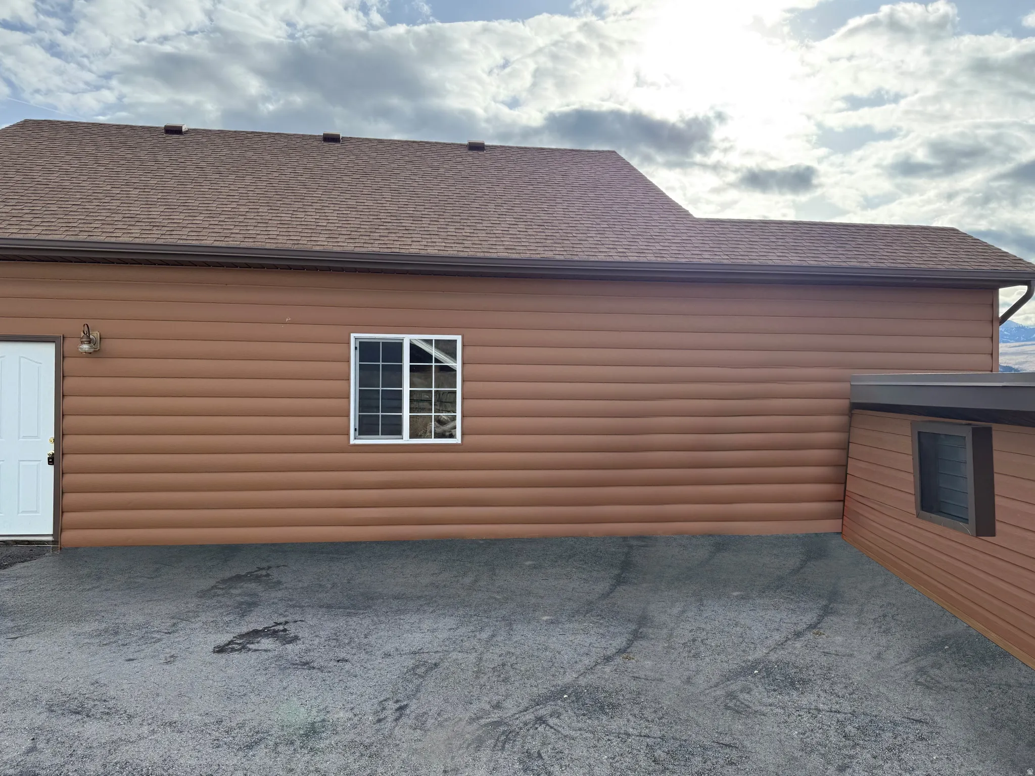 View of property exterior featuring a shingled roof