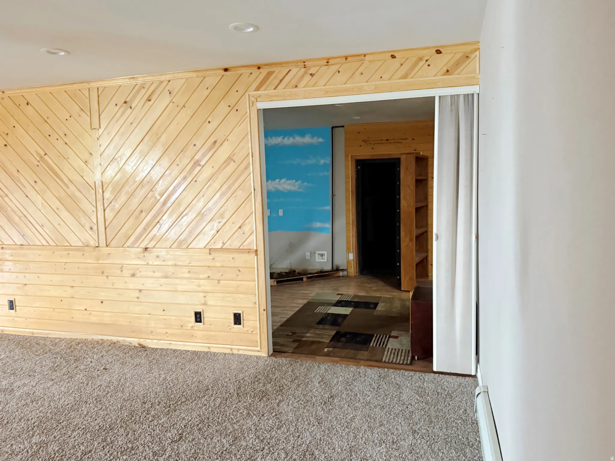 Hall featuring wood walls, carpet floors, and recessed lighting