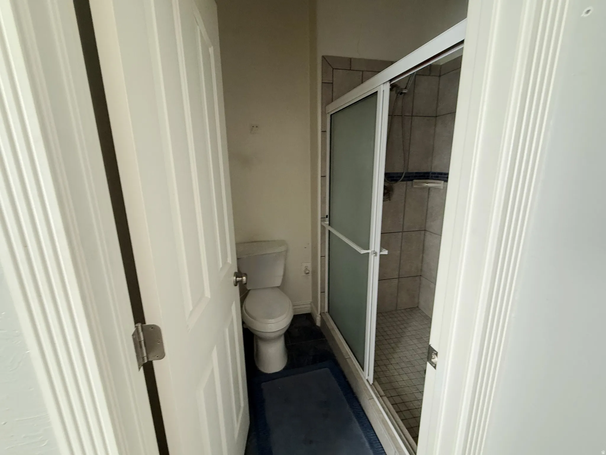 Full bath with a stall shower and toilet