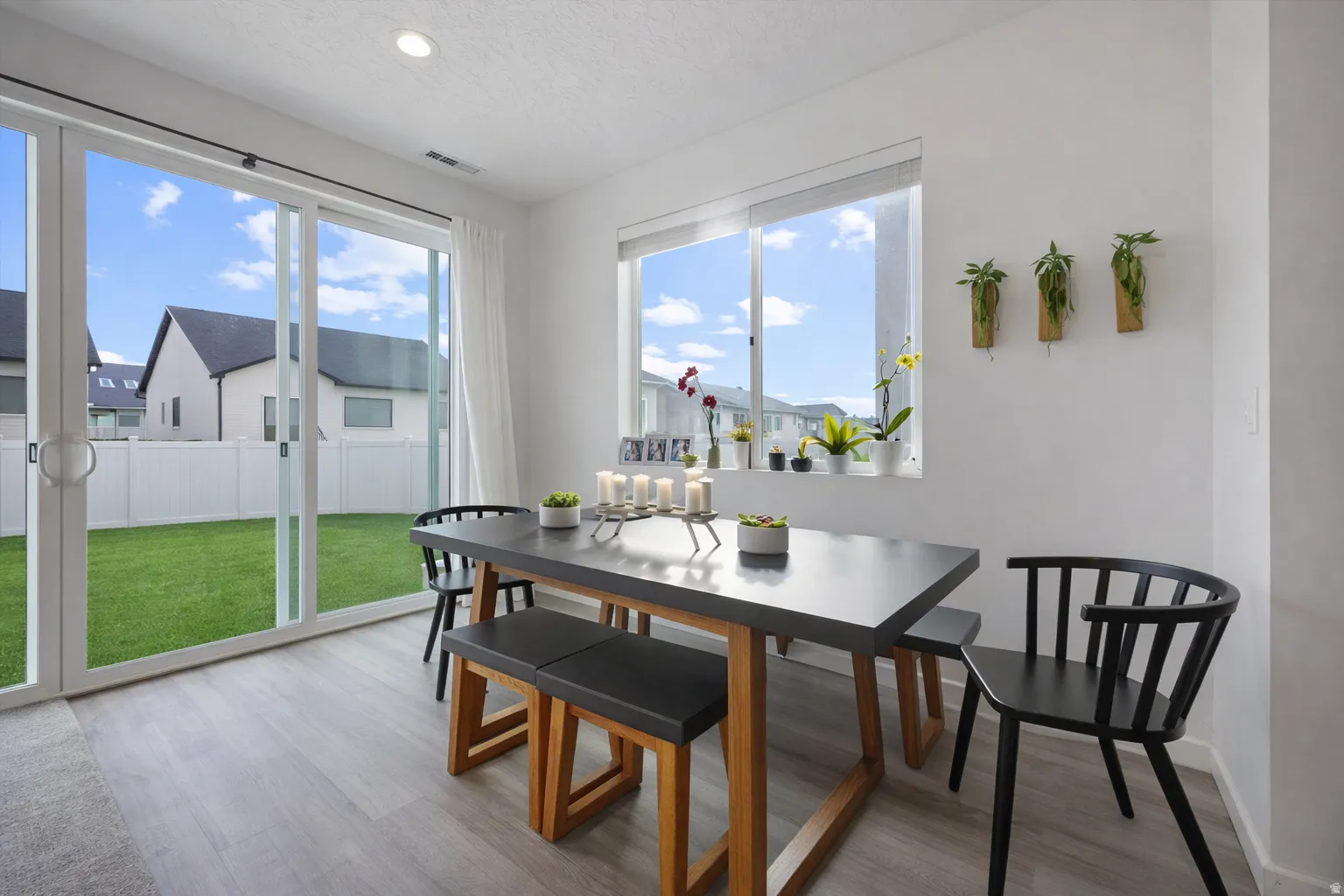 Dinning Area. ** Image has been edited to show what room would look like with grass in backyard**