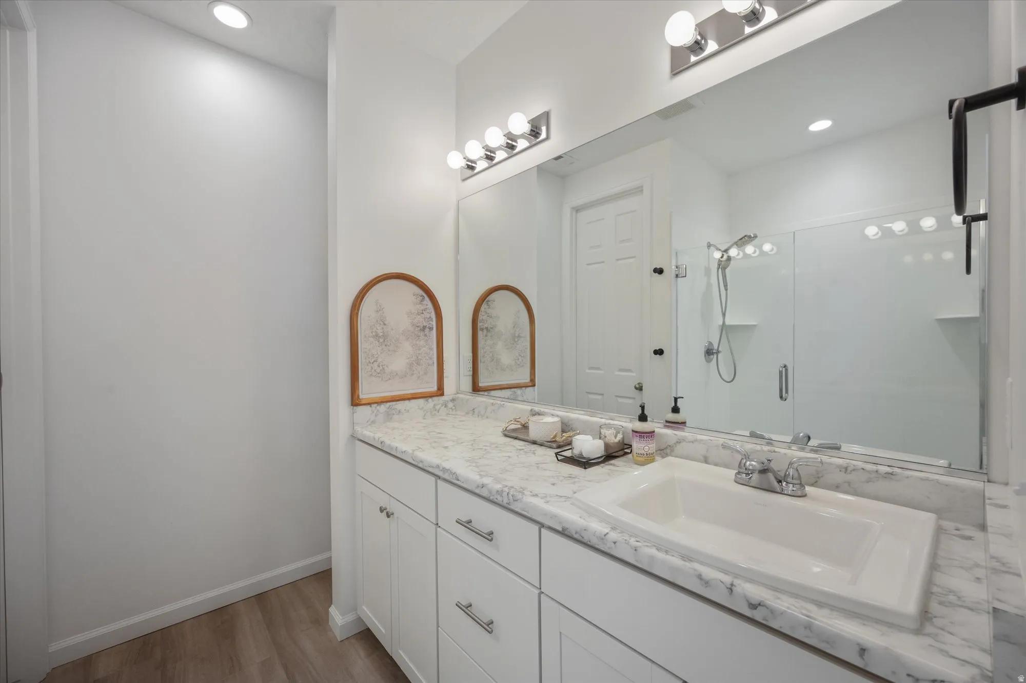 Primary bathroom. Large walk in shower, large vanity with sink, storage and private toilet room.