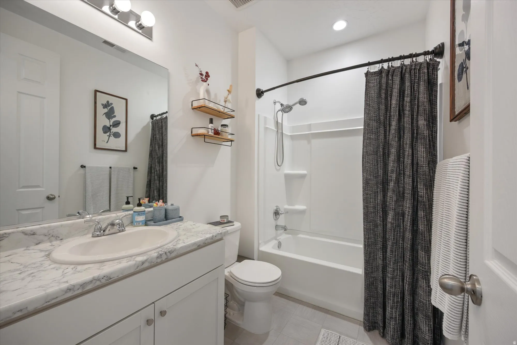 Full bathroom featuring vanity, shower / bath combination