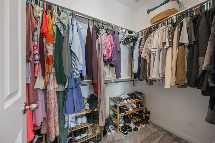 Walk in closet in primary bedroom