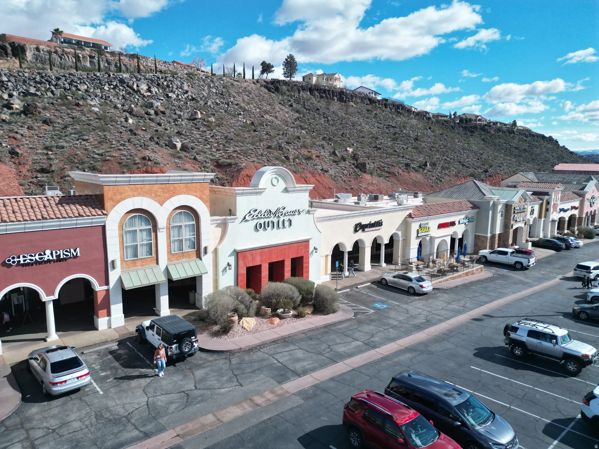 View of commercial property with uncovered parking and a mountain view