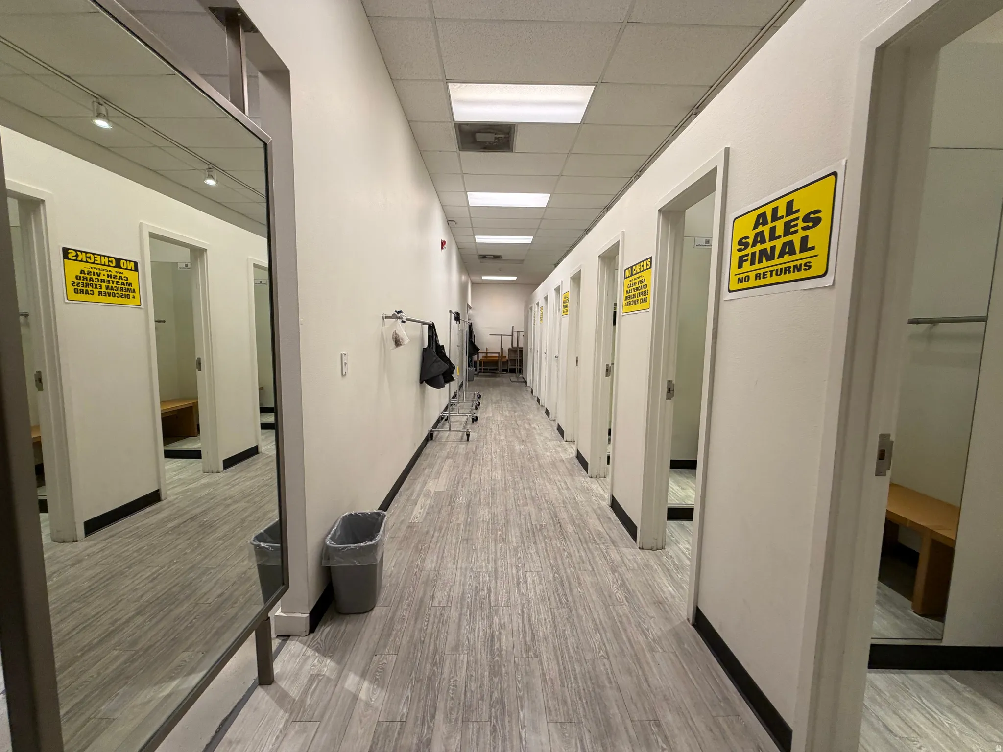 Hall featuring a drop ceiling and light wood-type flooring