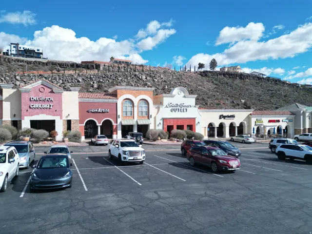 View of commercial location featuring uncovered parking