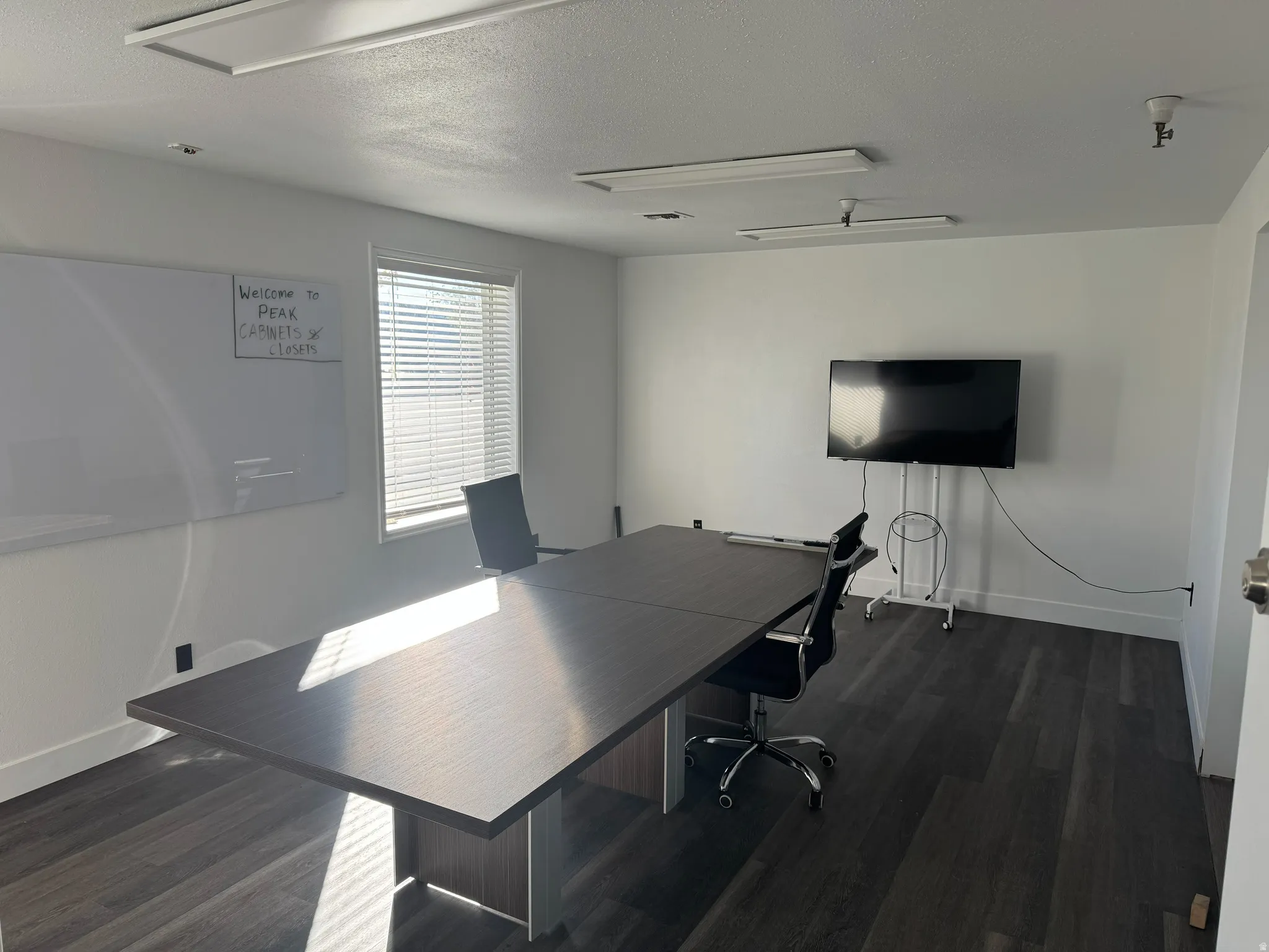 Office space featuring a textured ceiling