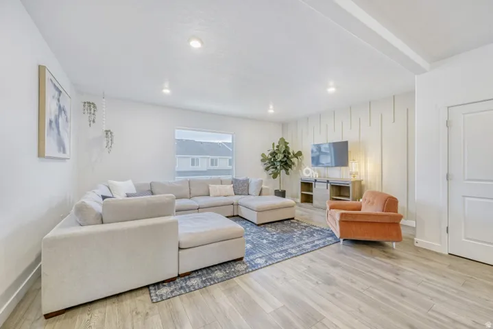 Living area featuring light wood-style floors and baseboards