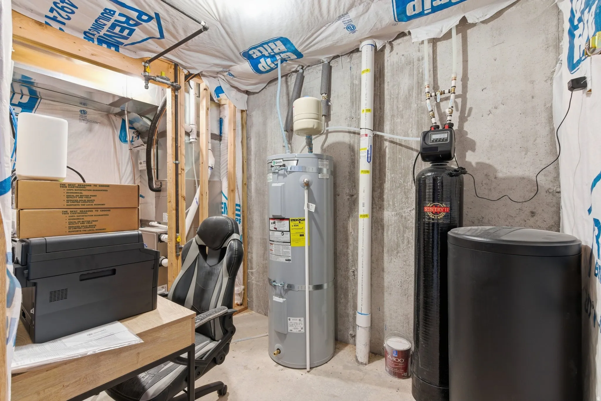 Utilities featuring strapped water heater and soft water system