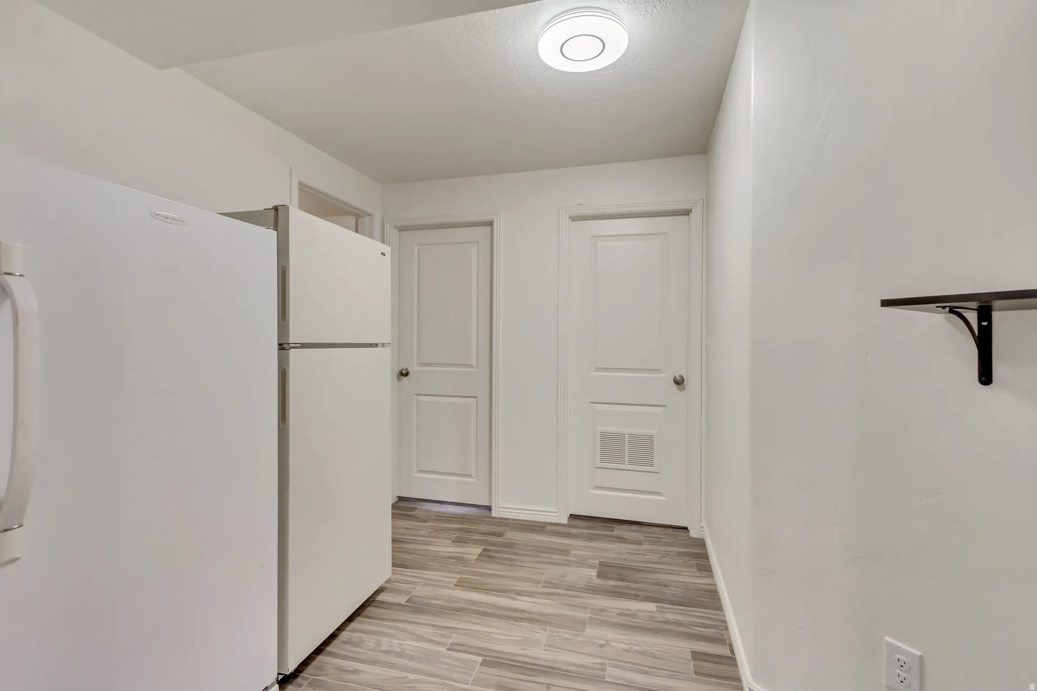 Hall featuring light wood-style floors and baseboards