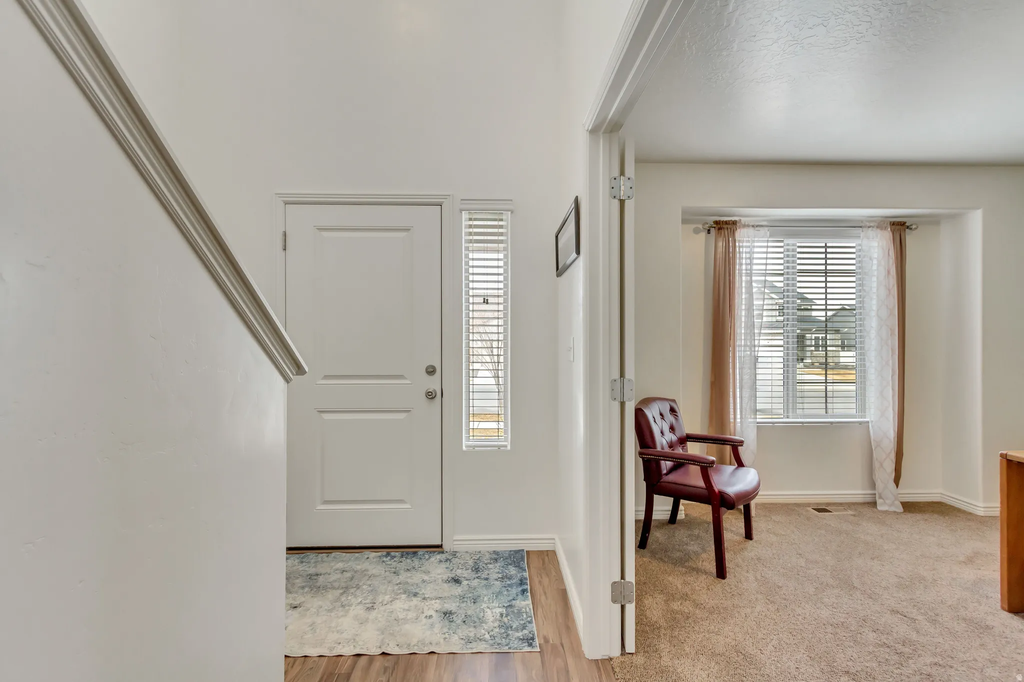 Entrance foyer featuring baseboards and light wood-style floors
