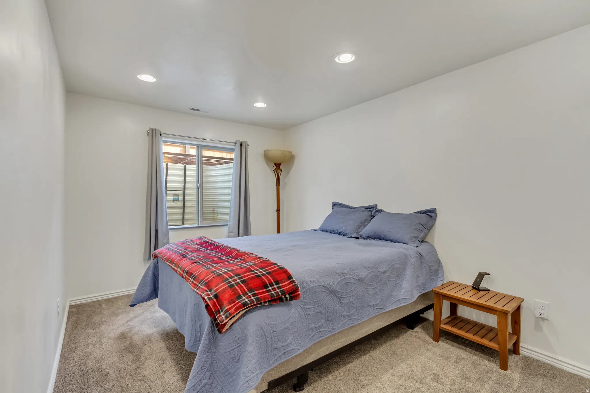 Bedroom with light carpet and recessed lighting
