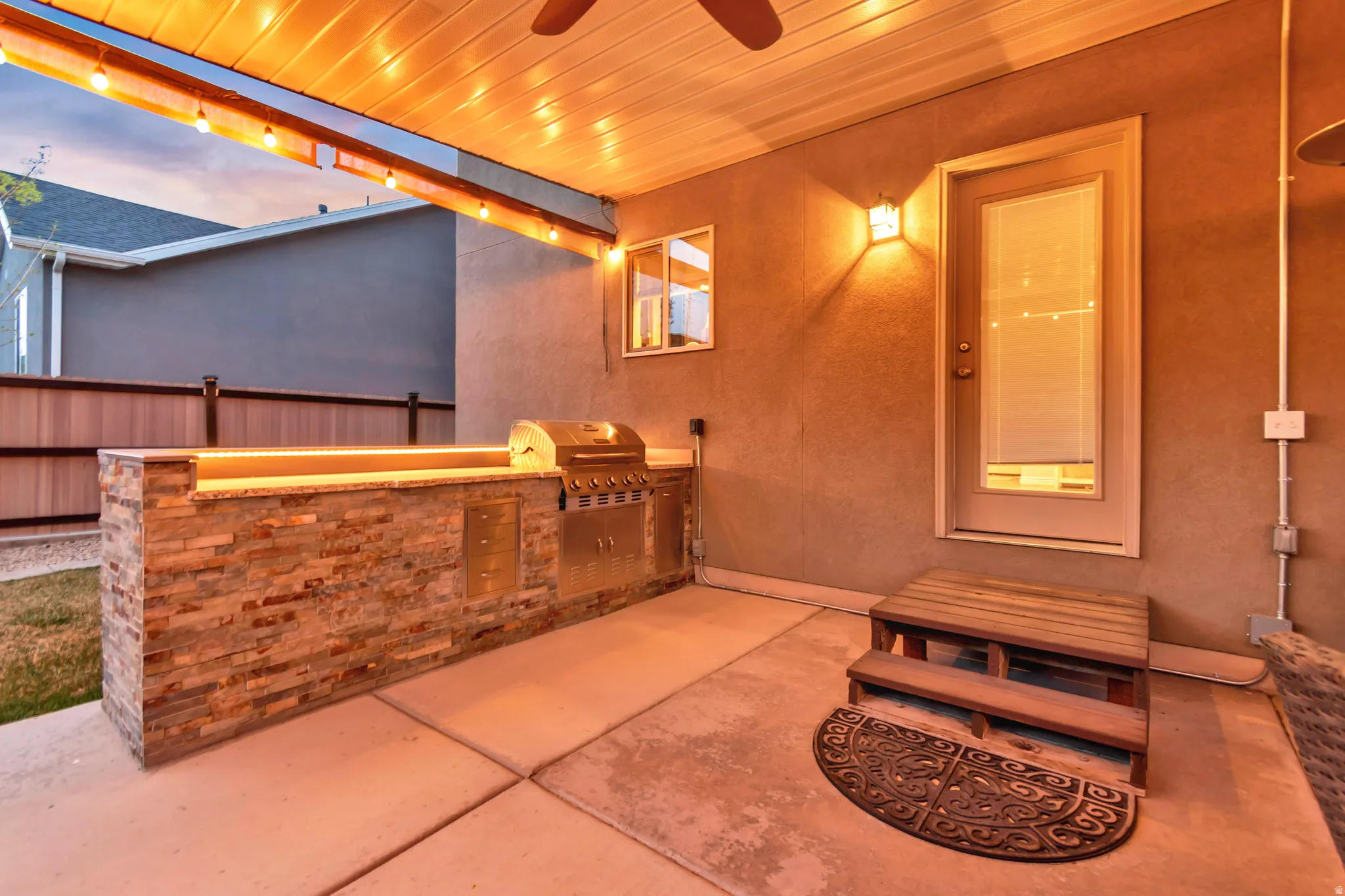 View of patio featuring exterior kitchen and a ceiling fan