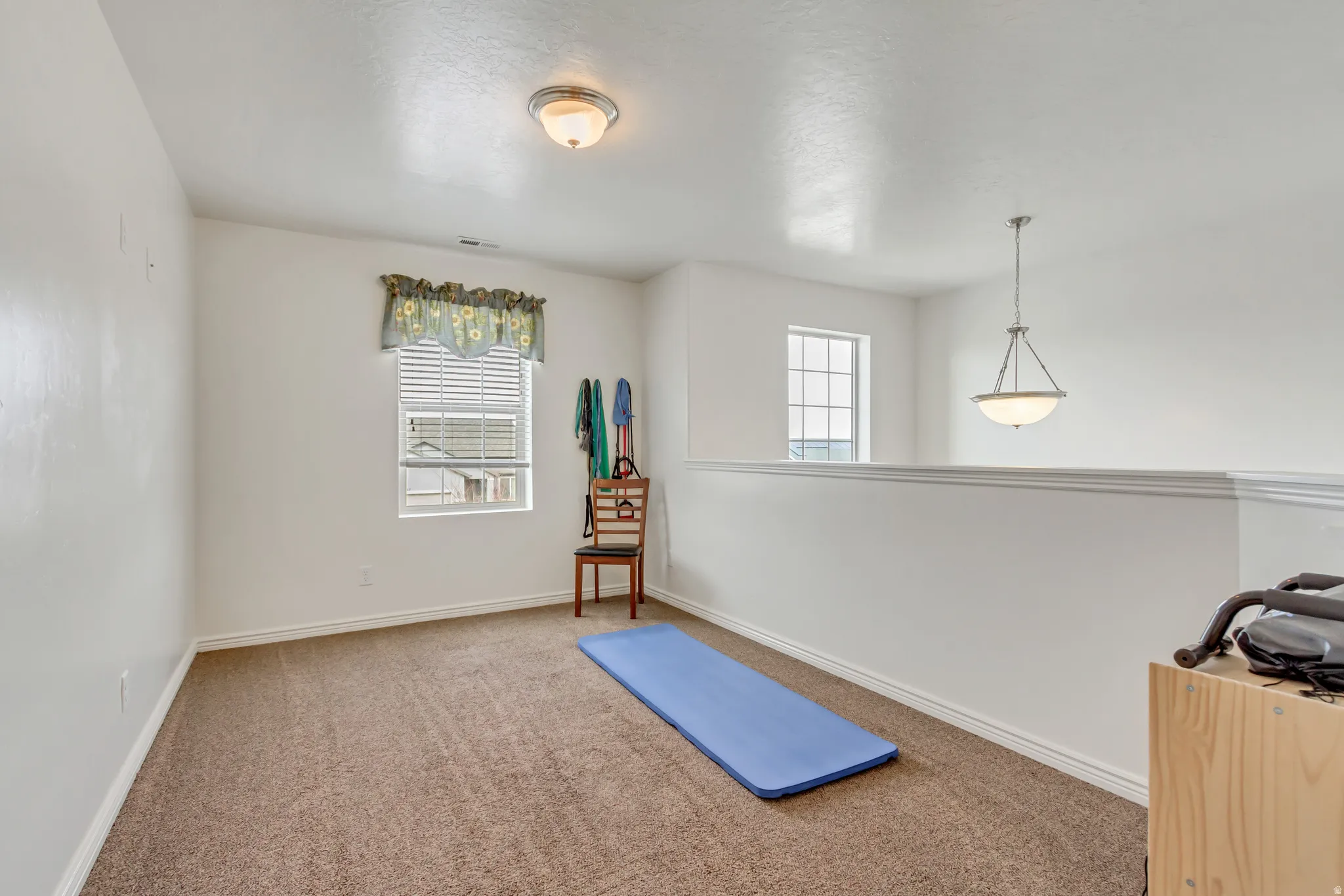 Workout area with carpet floors and plenty of natural light