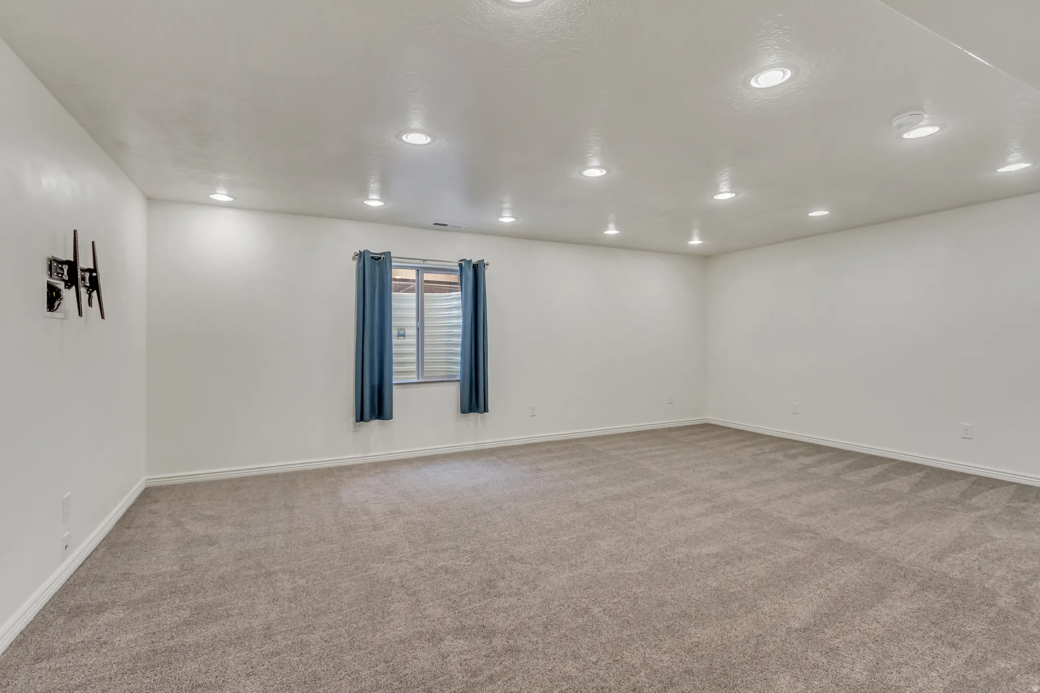 Spare room featuring light carpet and recessed lighting