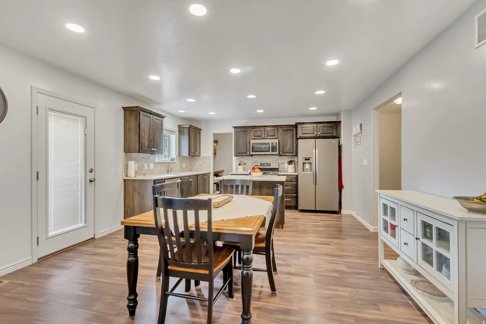 Dining area featuring light wood-style flooring and recessed lighting