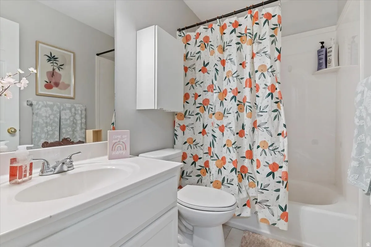 Bathroom featuring vanity and shower / tub combo with curtain