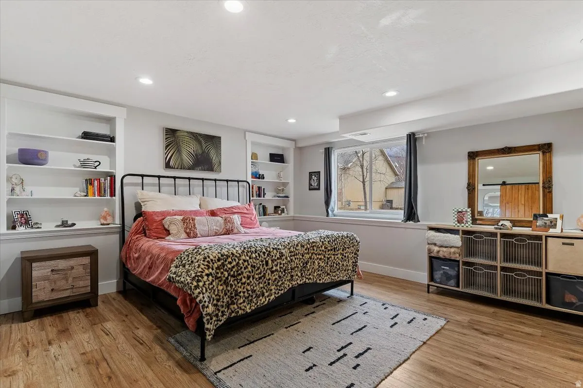 Bedroom with light wood-style floors and recessed lighting