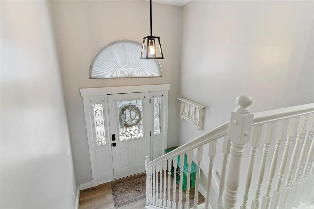 Entrance foyer featuring a high ceiling and light wood-style flooring