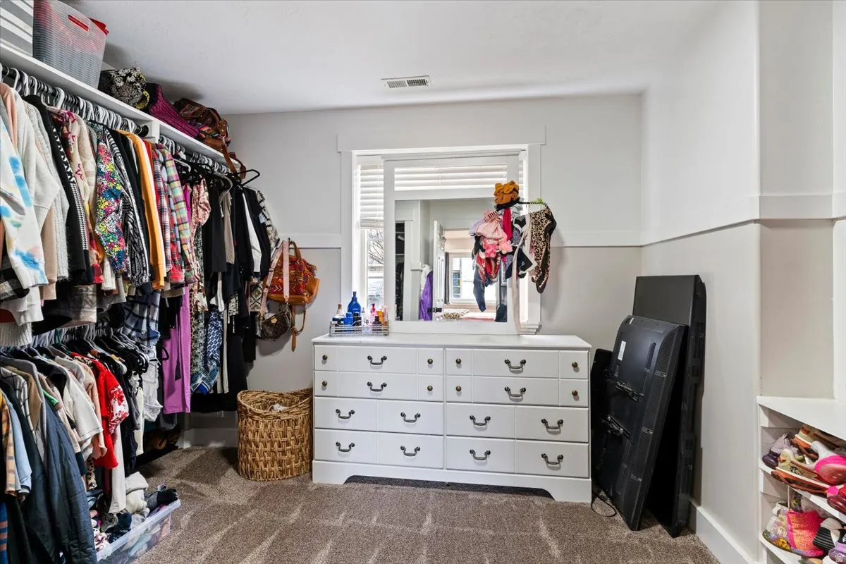 Walk in closet with dark carpet