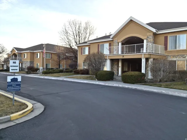 View of asphalt street featuring curbs and a residential view