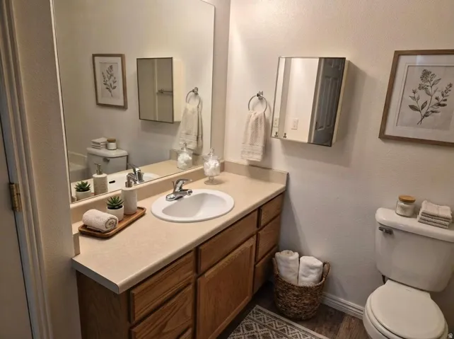 Bathroom featuring a textured wall and vanity bathtub and shower. Virtual staging