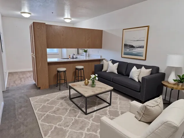 Living area with light colored carpet and baseboards