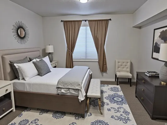 Bedroom featuring carpet flooring and baseboards