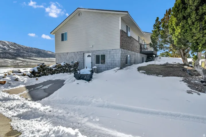 Snow covered property featuring a deck
