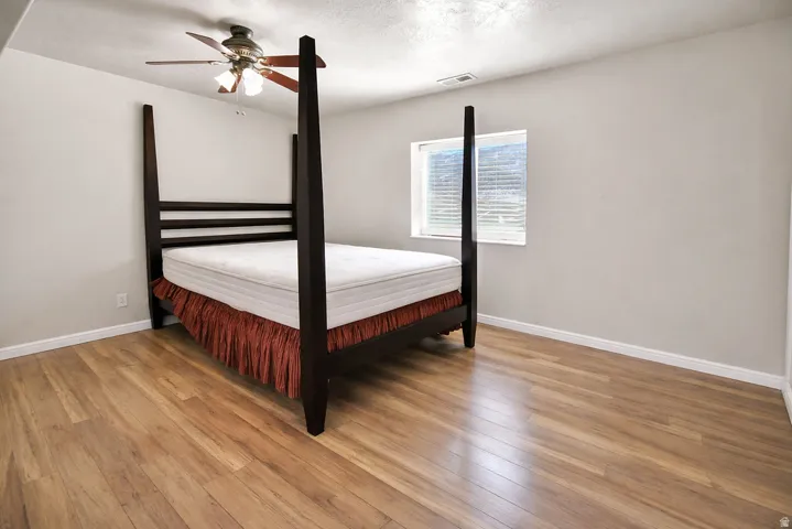 Bedroom with light wood-style floors and ceiling fan