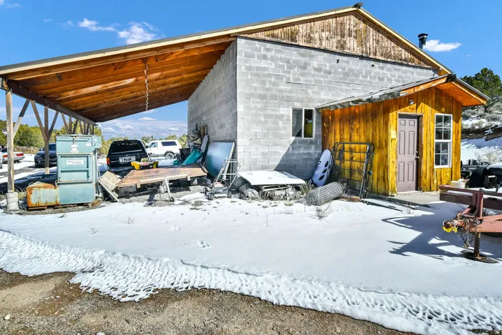 Snow covered structure with an attached carport