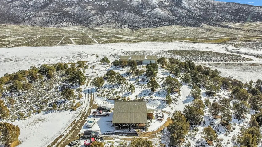 Snowy aerial view featuring a mountain view