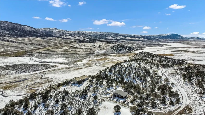 Snowy aerial view featuring a mountain view