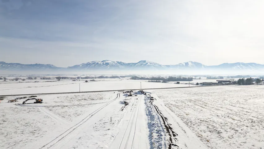 Snowy aerial view featuring a mountain view