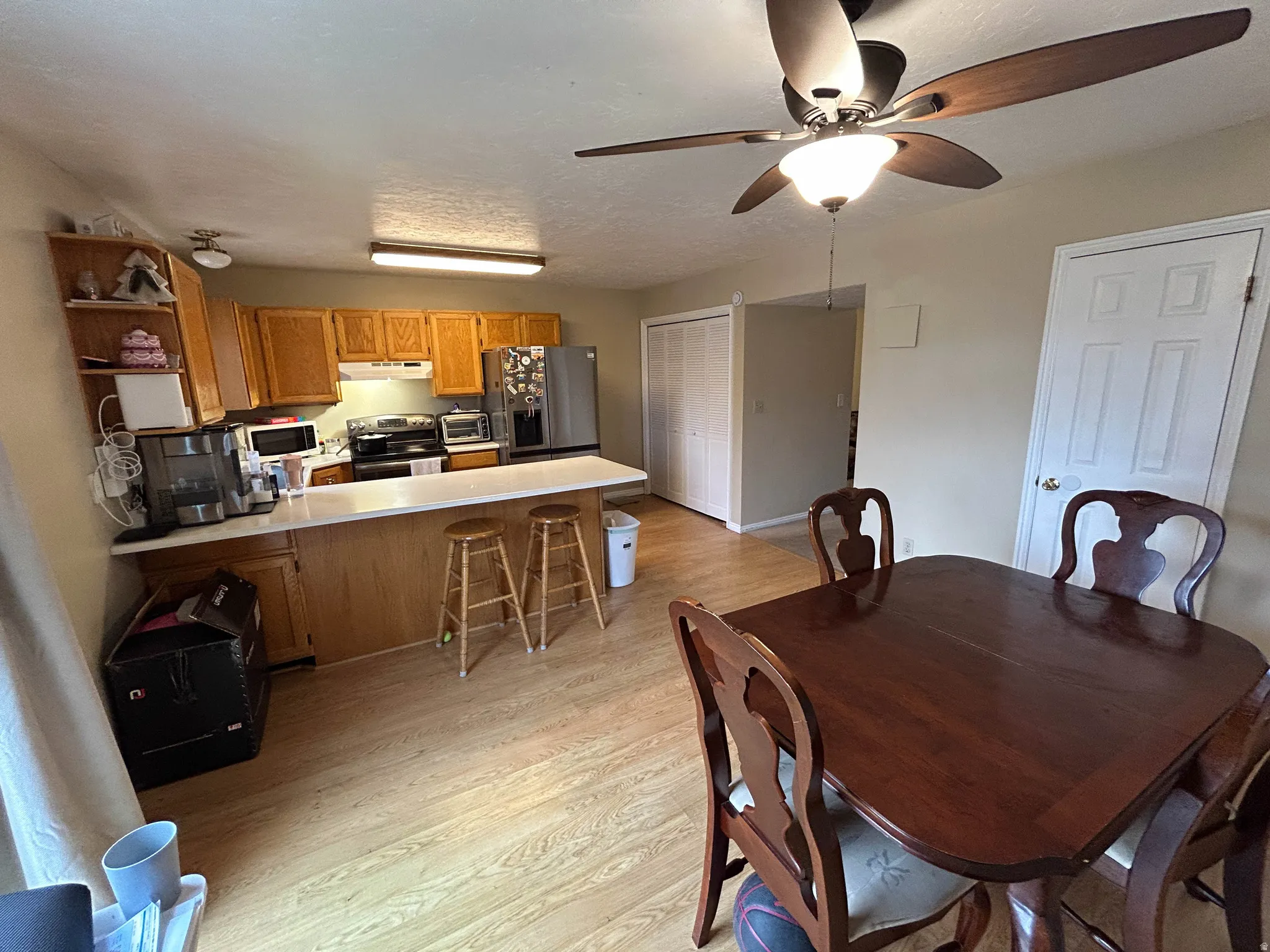 Dining space featuring light wood finished floors and a ceiling fan