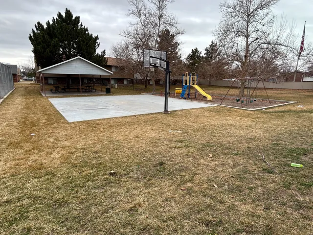 View of basketball court with a playground and basketball court
