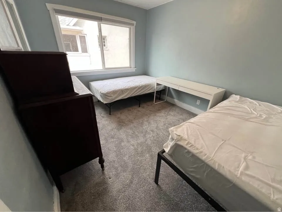 Bedroom featuring carpet flooring and baseboards