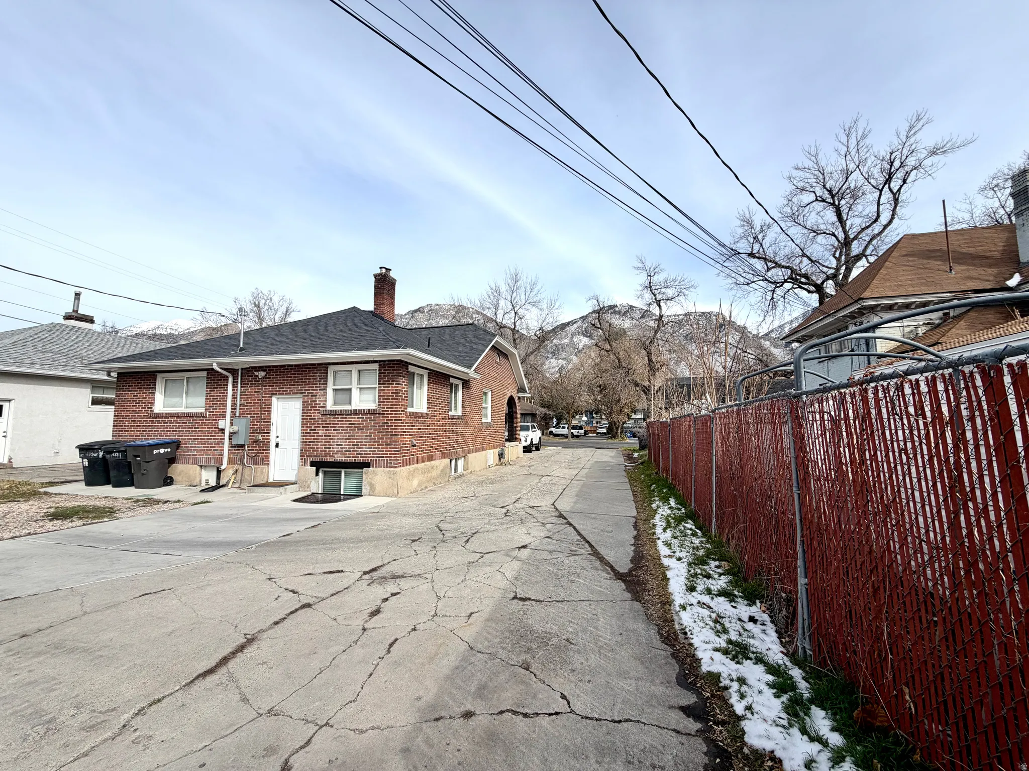 View of home's exterior with a chimney and brick siding