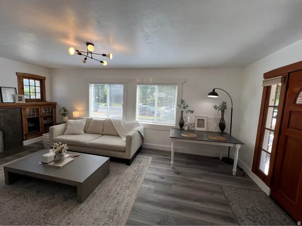 Living area with wood finished floors and baseboards