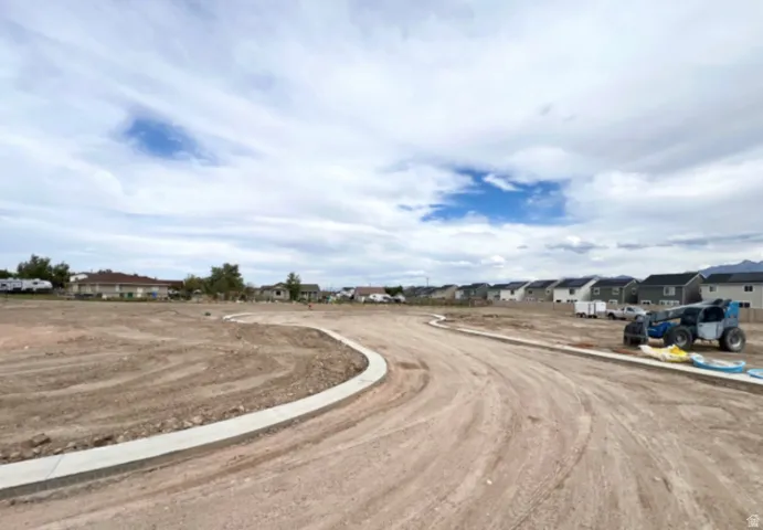 View of dirt / gravel road with a residential view
