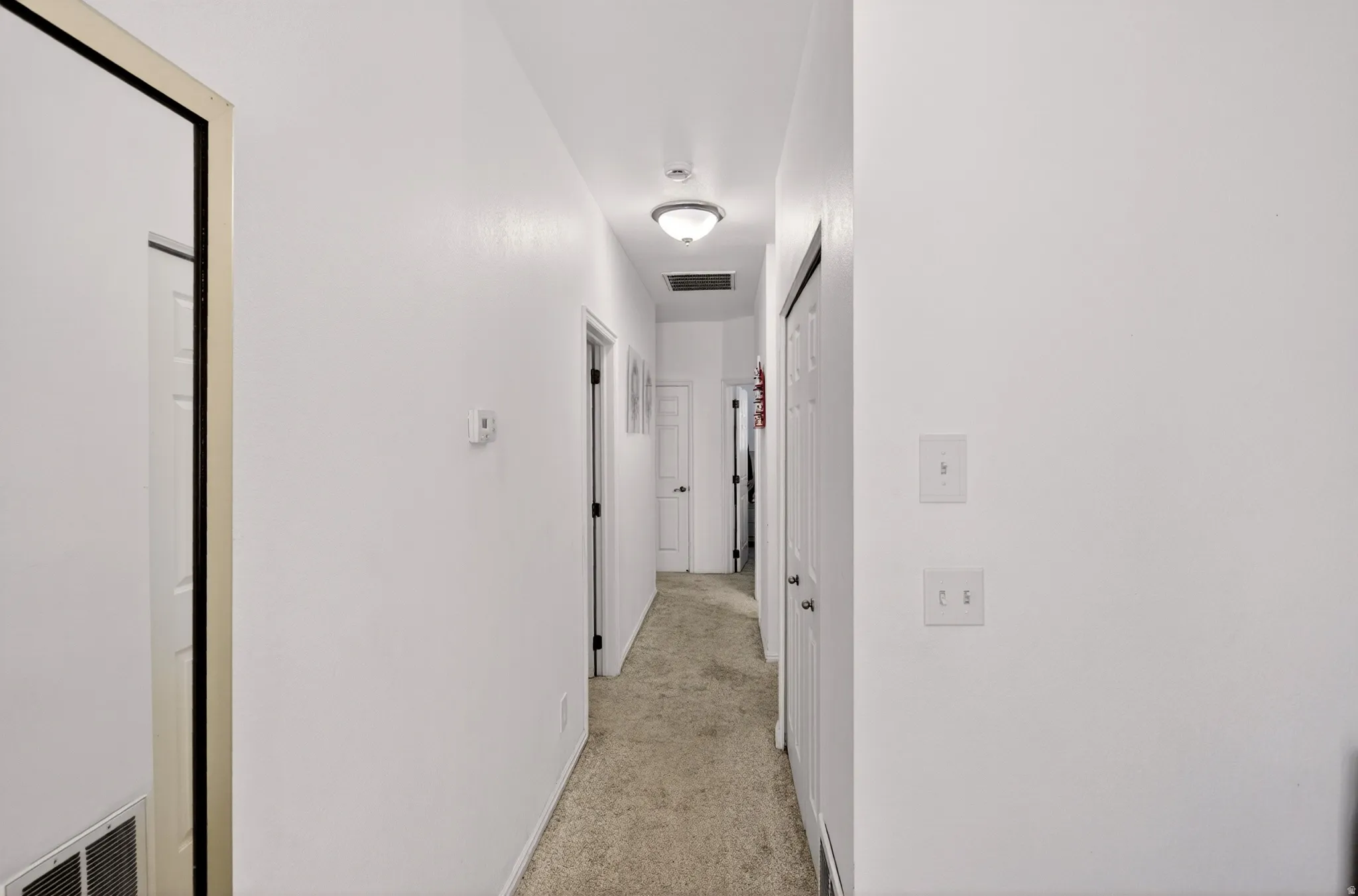 Hall featuring light carpet
